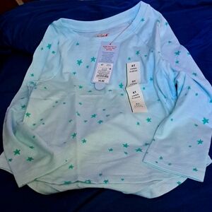 Size 4T long-sleeved t-shirt. Mint background with green stars all over.